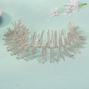 Detail shot of silver rhinestone bridal headband with feather pattern and sparkling tassels