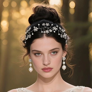 Close-up of bridal headband and matching pearl earrings with sparkling rhinestones