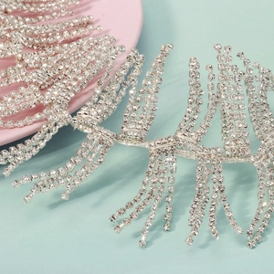 Detailed close-up of handmade bridal headband with sparkling rhinestones and silver fringe