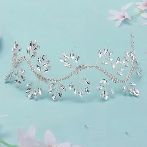 Detailed shot of silver bridal hair vine featuring marquise rhinestones on a blue base