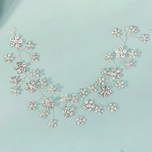 Macro detail of bridal hair vine with silver wire, rhinestones and small white pearls