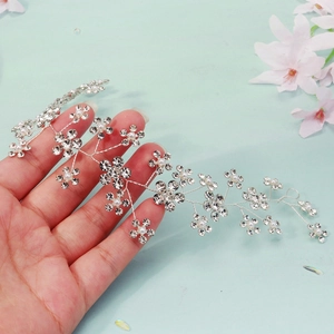 Detail of handmade bridal hair vine with silver wire, rhinestones and white pearls