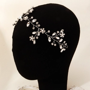 Detail of handmade bridal hair vine with silver floral wire, rhinestones and pearls