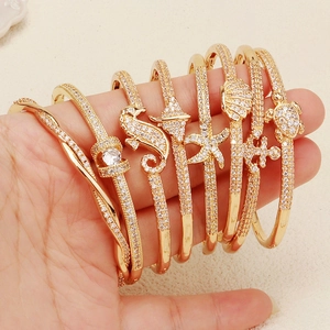 Ocean theme sea star and shell gold plated bangles with white zircon inlays set
