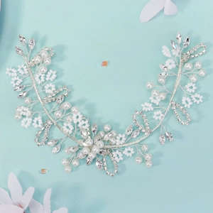 Macro detail of handmade bridal headband with white pearls and sparkling floral crystals