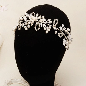 Elegant bridal headband featuring handmade white pearls and crystal flower vine on a model