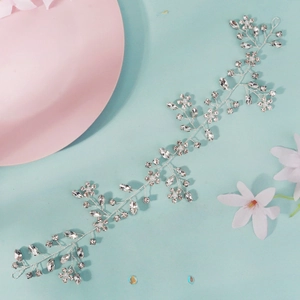 Close-up of silver bridal hair vine with marquise rhinestones and white pearls on blue back