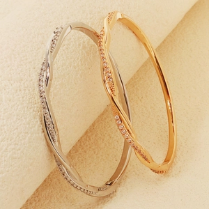 Elegant ocean-style intertwined wave bracelets in gold and silver with white zircons
