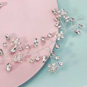 Detailed view of handmade silver bridal hair vine with marquise rhinestones and white pearls