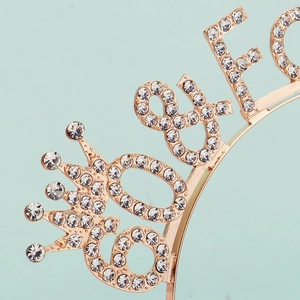 Detailed macro view of the sparkling rose gold 80th birthday tiara with inlaid white rhinestones