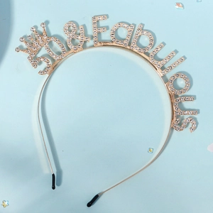Detail view of gold 50 and Fabulous headband with rhinestones and crown for birthday party