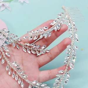 Detail of silver bridal hair vine with crystal leaves and comb on blue background