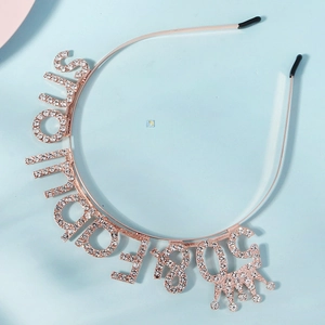 Detail of rose gold stupendous letter headband with sparkling crystals and crown motif