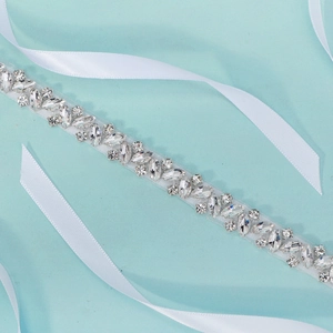Close-up of sparkling clear rhinestones on bridal belt with silver metal settings