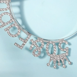 Close-up of silver 80th birthday crown headband with sparkling rhinestones and letters