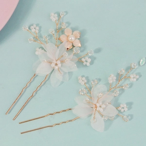 Detail of bridal hairpins with handmade silk petals and ivory pearls in gold finish