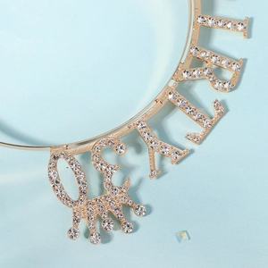 Macro shot of gold Birthday Girl headband featuring sparkling rhinestones and a small crown
