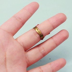 Close-up of vintage bronze gothic ring with red rose ornament on an adjustable band