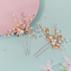 Detailed view of pearl leaf hairpins with golden wire weaving for bridal hairstyles