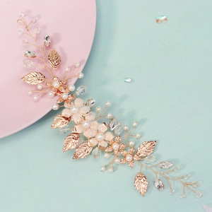 Detail of bridal hair vine with rose gold wire, pearls, fabric flowers and crystals