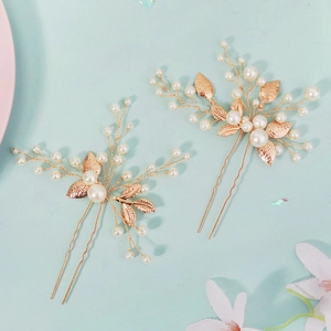 Elegant bridal hair pins with gold leaves and white pearls for wedding hairstyles