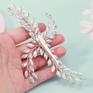Silver bridal hair clip featuring crystal leaves and a branch design on a duckbill clip