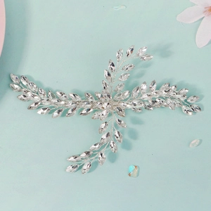 Detailed macro view of silver bridal hair clip with marquise rhinestones and vine pattern