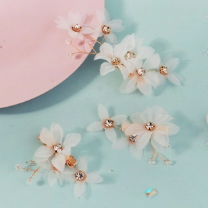 Detailed macro of handmade double-layer mesh flower hair clips with gold accents and crystals