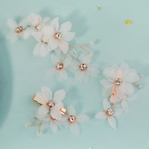 Three-piece set of white tulle flower hair clips with rhinestones for bridal styling