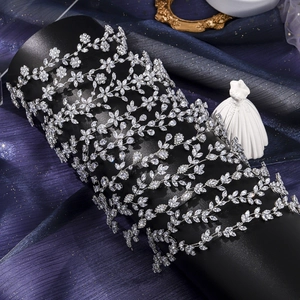 Detailed macro view of silver leaf zircon tiara displayed on a dark cylinder stand