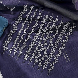 Detailed set of silver zircon bridal hair vines and pins on elegant dark fabric