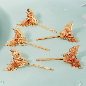 Golden butterfly hair clips set with hollow wings and crystals for bridal styling
