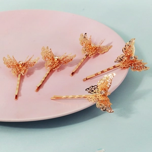 Set of 5 gold butterfly hair clips with hollow floral pattern and white crystal centers