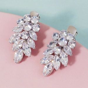 Close-up of sparkling leaf-shaped zircon hair clips with elegant silver metal base