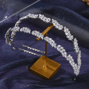 Detailed view of silver bridal headband with leaf shaped crystals and matching hair pins