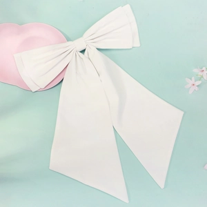 Elegant large white satin wedding bow accessory with long ribbons on mint background