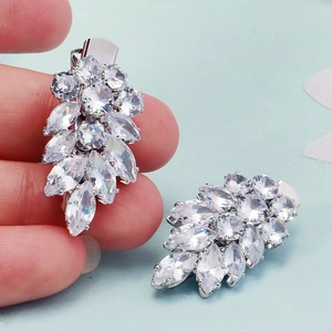 Detailed macro view of silver leaf hair clips with marquise-cut sparkling zircons