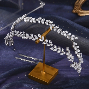 Detail of luxury zircon laurel crown tiara and matching hairpins on a stand