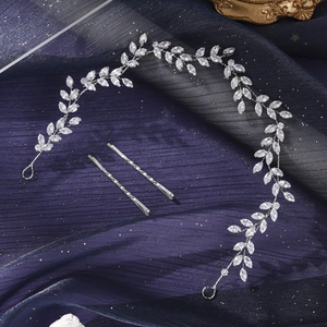 Close-up of silver bridal hair vine and matching leaf-shaped crystal hair pins set