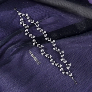 Detail view of luxurious bridal hair vine with silver zircon flowers and matching hair pins
