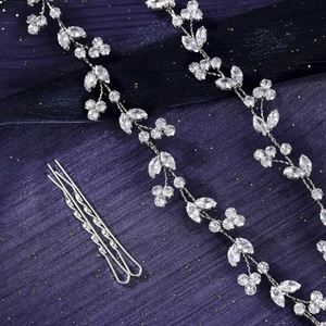 Detail of luxury bridal hair vine set with marquise cut zircons on sparkling blue fabric