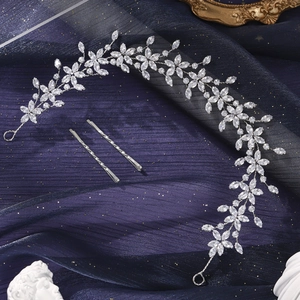 Detailed macro view of silver vine bridal headband and hair pins with sparkling crystals