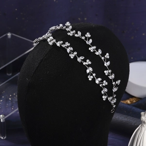 Detail of luxury bridal zirconia headband with floral vine design on a black mannequin head