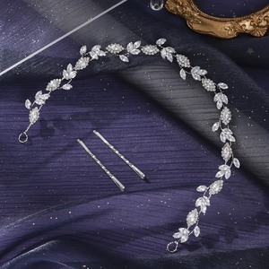 Detail of silver floral bridal hair vine set with marquise rhinestones on blue tulle