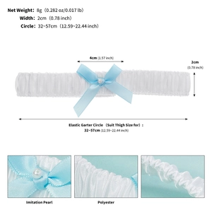 Macro shot of white lace garter featuring a light blue bow and faux pearl detail