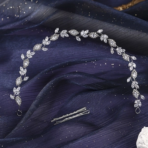Detailed view of silver vine bridal headpiece with marquise crystals on navy tulle