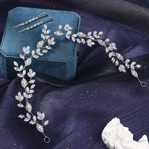 Detailed view of silver vine bridal headband with marquise zircons on purple silk fabric