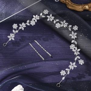 Detail view of silver bridal hairband with sparkling crystals and matching hairpins