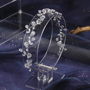 Macro shot of silver vine bridal tiara with sparkling pear-cut rhinestones on navy velvet