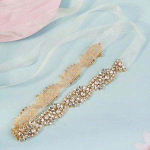 Macro detail of luxury wedding belt featuring vine patterns of marquise rhinestones